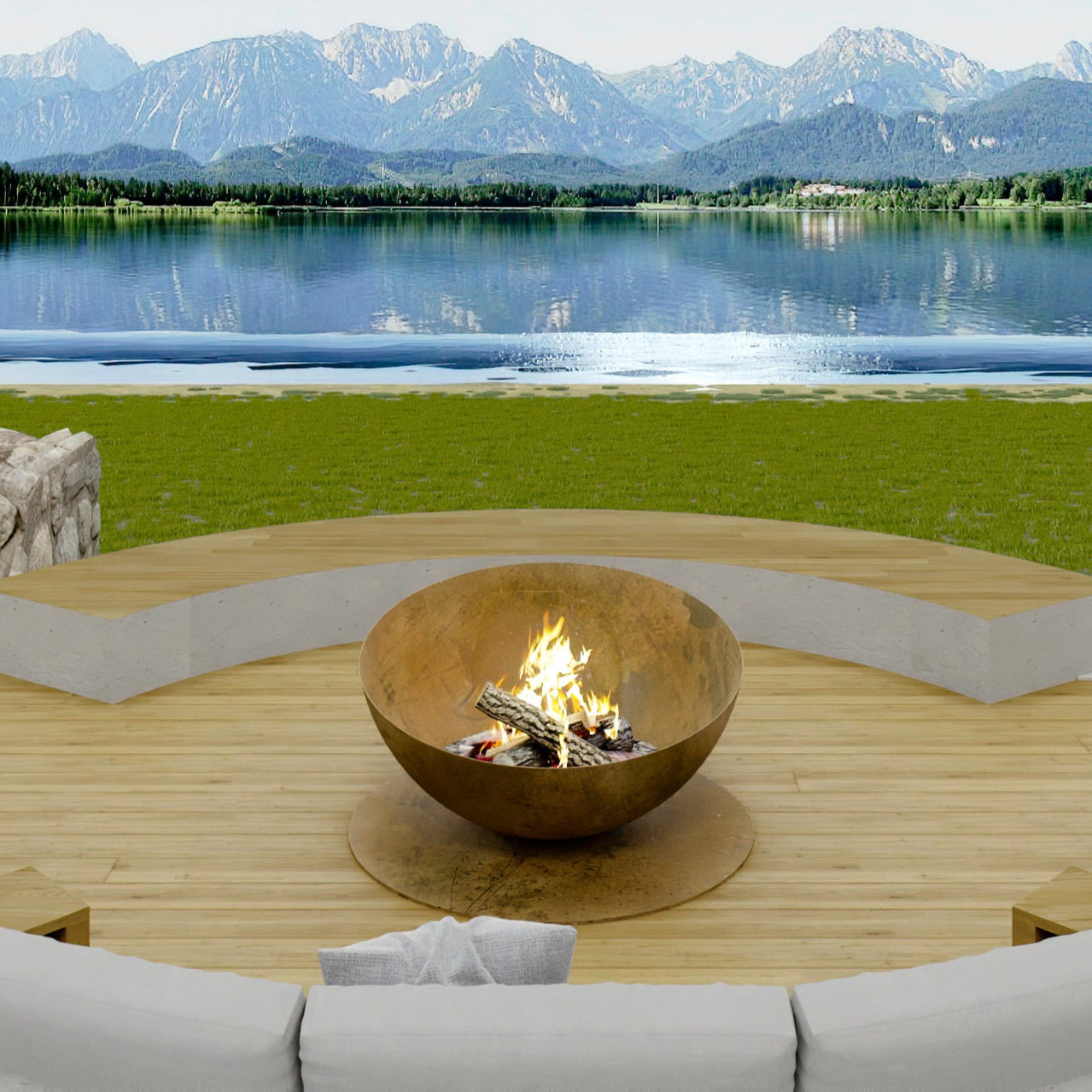 Outdoor seating area with a fire pit by a lake and mountains