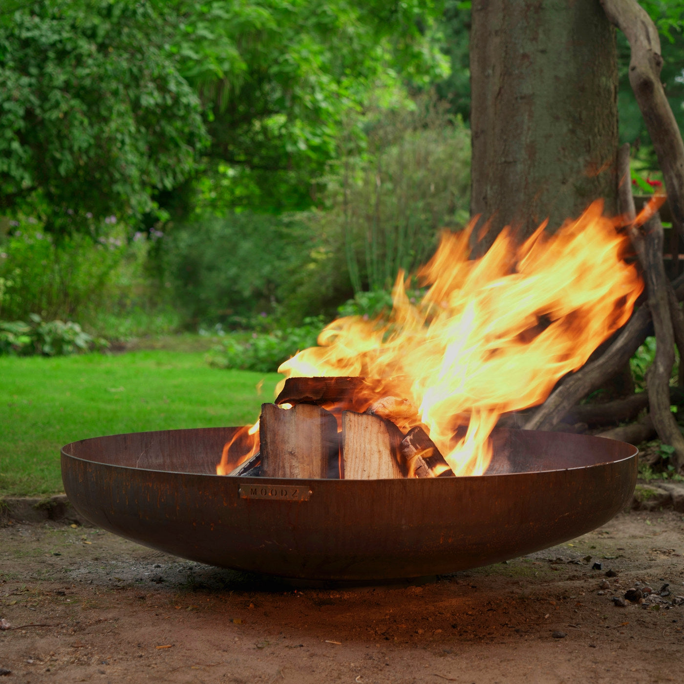 MOODZ Firebowl 150 Corten Steel in a garden setting